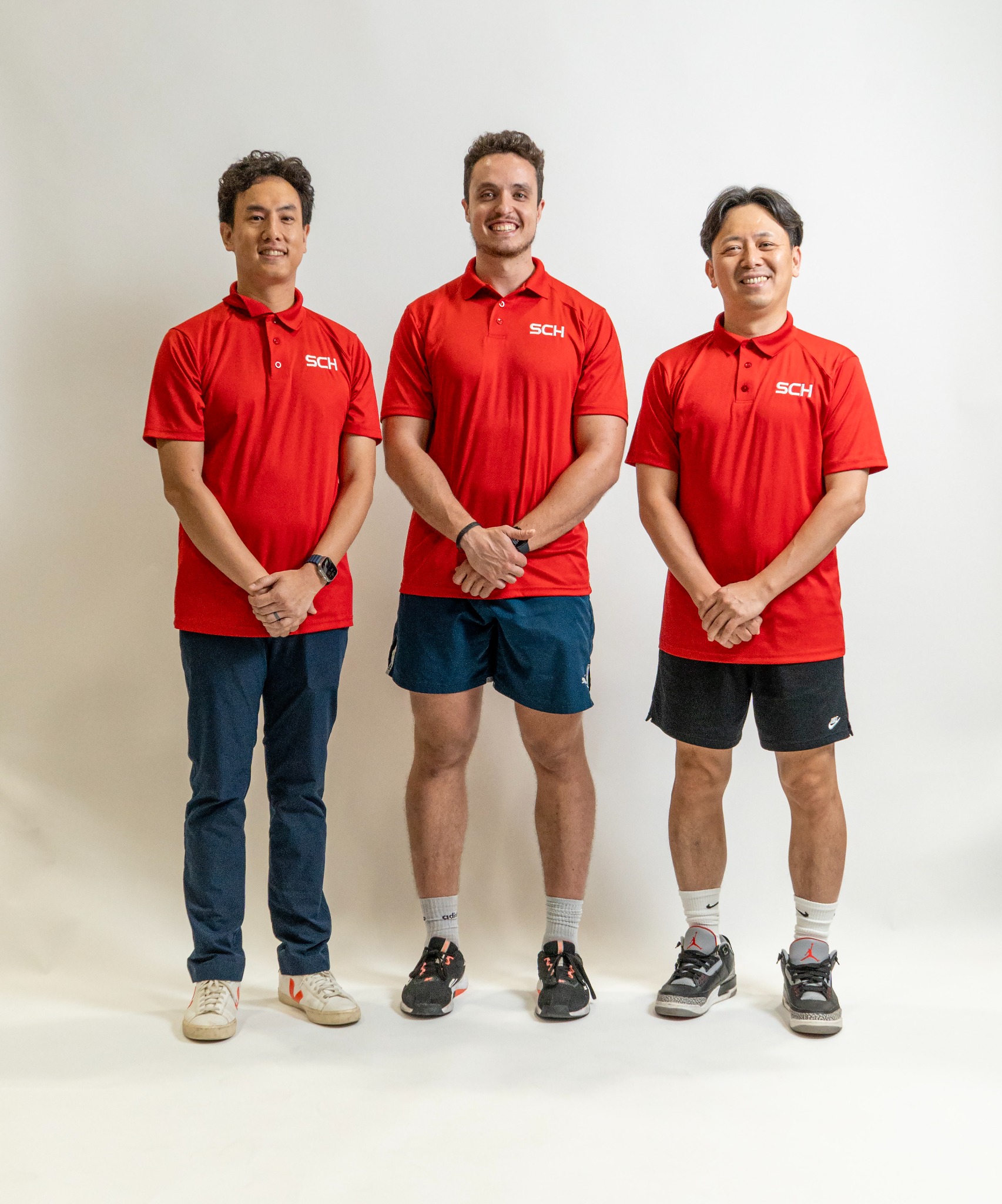 Space City Hoops coaching staff in red polos