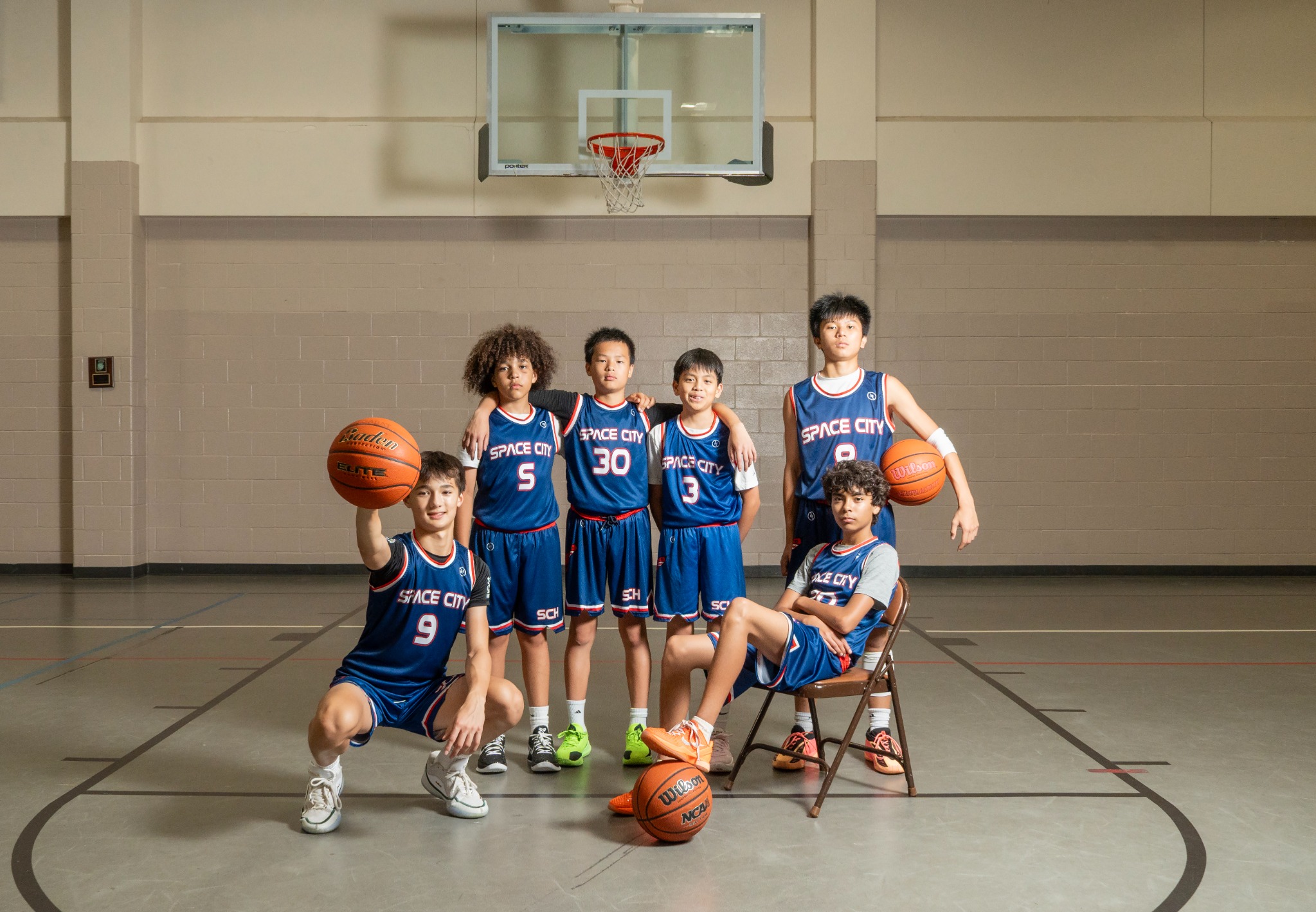 Space City Hoops players posing together with basketballs